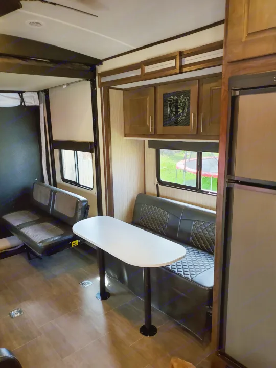 Spacious RV rental interior featuring dining area, kitchen, and convertible bunk beds, perfect for family adventures.. Cruiser Rv Corp Stryker 2020