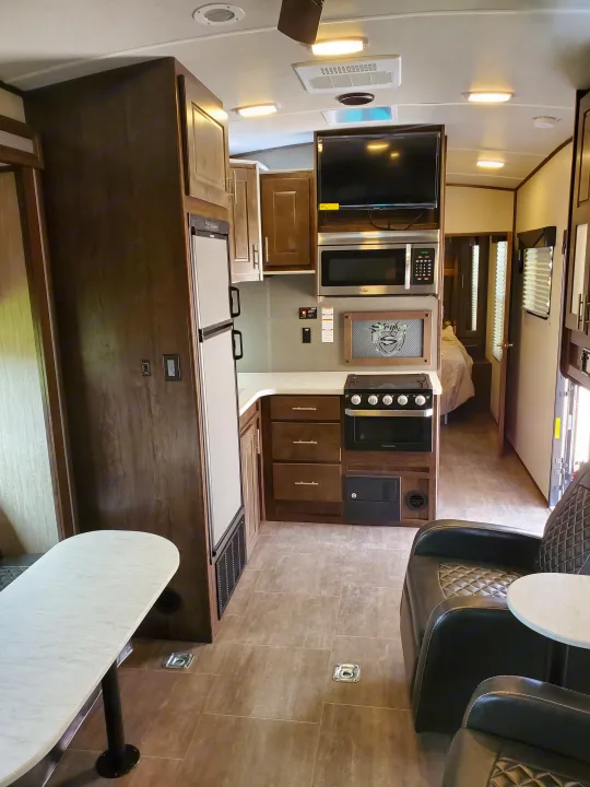 RV rental interior showing a full kitchen, living area with seating, and a glimpse into the bedroom.. Cruiser Rv Corp Stryker 2020