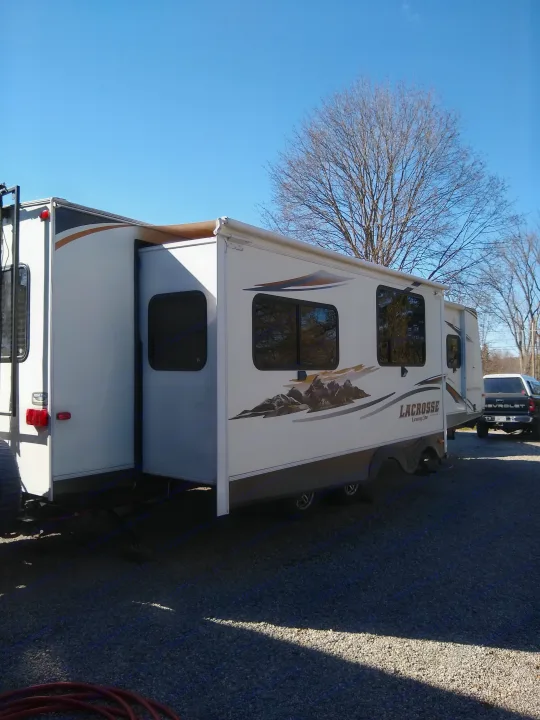 Spacious LaCrosse travel trailer RV with extended slide-outs, ideal for your next RV rental adventure under clear skies.. Prime Time Lacrosse 2013