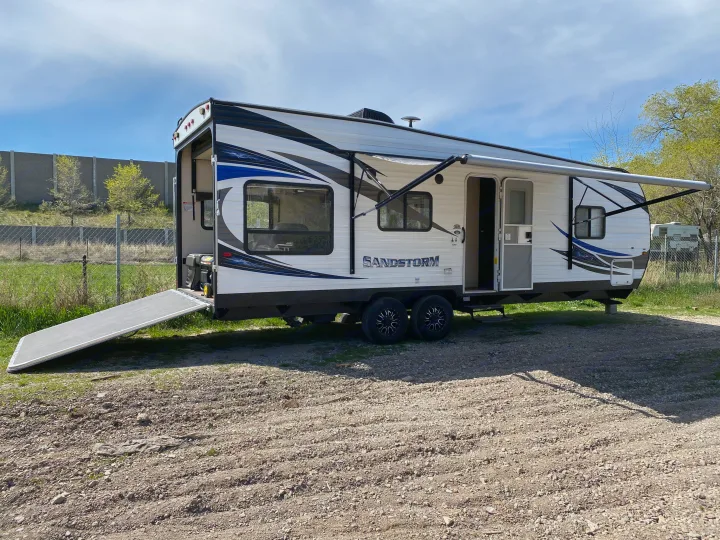 This Sandstorm RV rental features an extended awning and rear ramp, perfect for outdoor adventure and toy hauling.. Forest River Sandstorm 2017