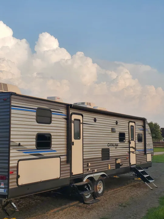 Side, showcasing dual entry and A/Cs. Coachmen Catalina 321BHDS 2020