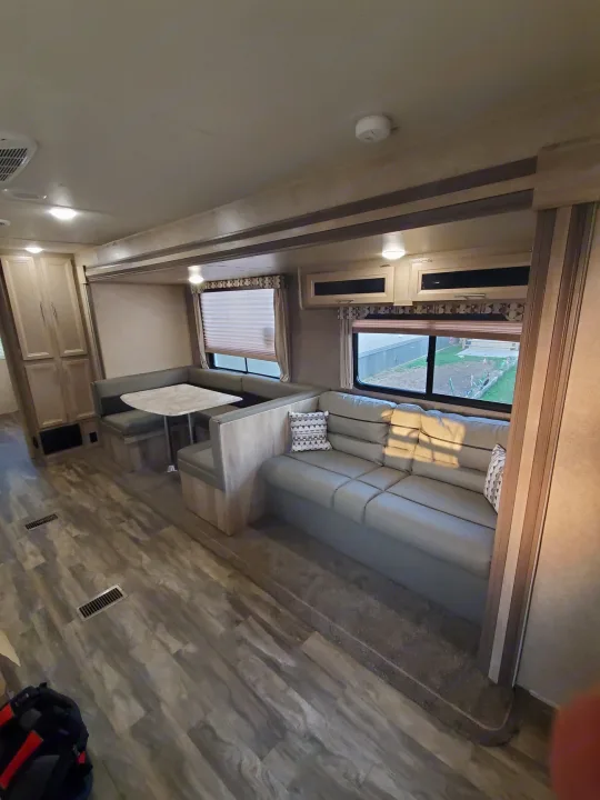 Couch, pulls into sleeper with overhead storage. Coachmen Catalina 321BHDS 2020