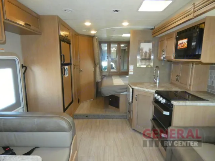 This RV rental features a full interior view: kitchen, living area with a bench, and a rear bedroom.. Thor Motor Coach Quantum SE27 2020