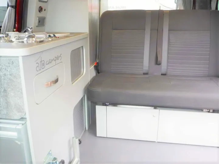 This RV rental offers a well-designed camper interior with a kitchenette, belted rear seat, & storage solutions.. Ford Transit Custom 2+2 berth Pop Top, Manual 2021