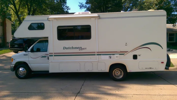 This white Class C Dutchmen Express RV rental is parked on a sunny day, ready for your next road trip adventure.. Dutchmen Other 2001