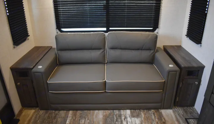 Gray RV theater seating with cupholders & side tables, perfect for your next RV rental. Cozy interior.. Starcraft Travel Trailer 2020