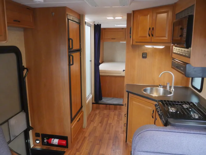 View of kitchen, bath, hallway, and master bedroom from the bed above the cab! :). Thor Majestic 2015