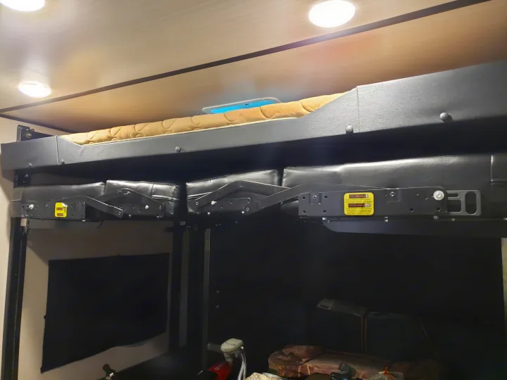 RV rental interior: versatile bunk bed above a convertible sofa, ideal for optimizing space in a camper.. Forest River XLR hyperlite 2019