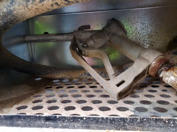 RV rental fuel nozzle and hose, grimy and rusty, stored in its perforated bay.. Forest River XLR hyperlite 2019