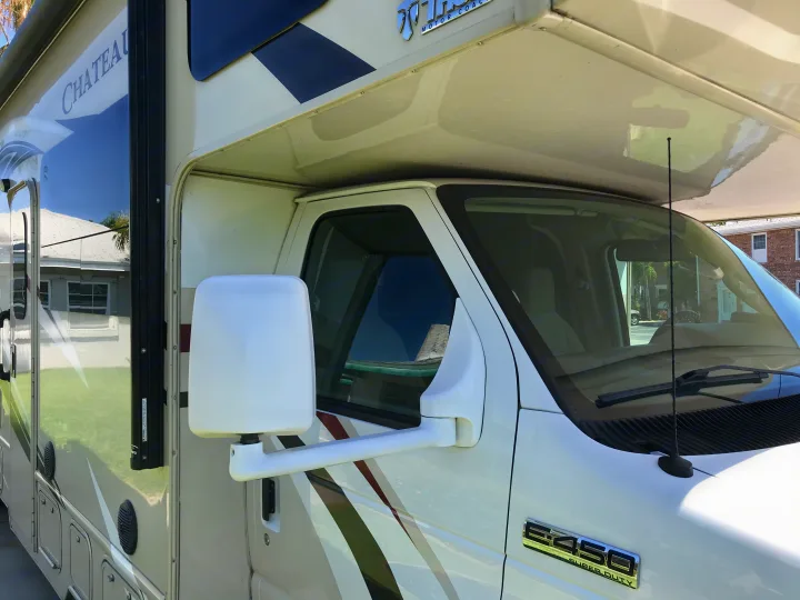 This white Chateau RV rental, built on a Ford E-450 Super Duty chassis by Thor Motor Coach, is parked outdoors.. Thor Chateau 2020
