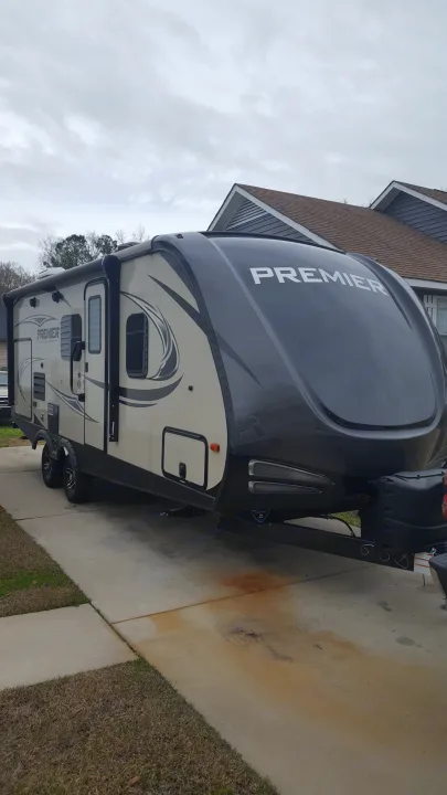 Premier travel trailer RV parked on a driveway. Consider this comfortable option for your next rv rental getaway.. Keystone RV Bullet Premier 2019
