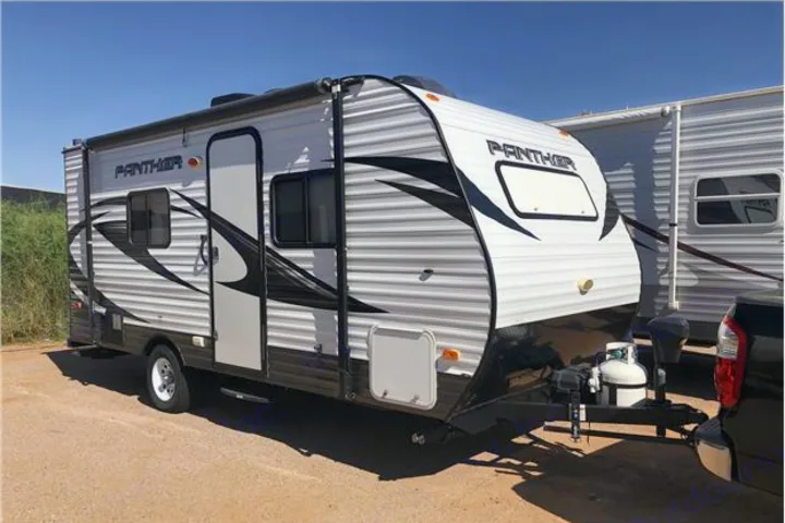 This Panther travel trailer, ideal for your next rv rental, is parked outdoors on a sunny day.. Pacific Coachworks Panther 2016