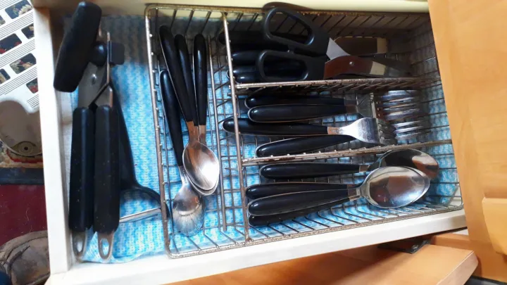 RV rental kitchen drawer neatly holds black-handled utensils: shears, can opener, and flatware in a caddy on a blue mat.. Fiat Ducato Swift Suntor 2000