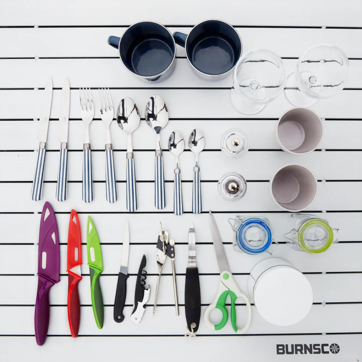 Essential kitchenware for your RV rental: a comprehensive set including striped cutlery, mugs, glasses, and various camping tools.. Toyota Voxy 2007