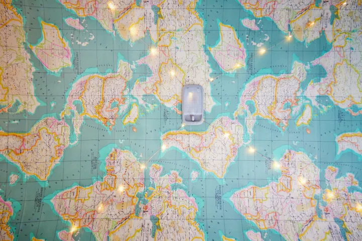 A detailed world map with an overhead RV light fixture and string lights, ideal for planning an rv rental journey.. Toyota Voxy 2007