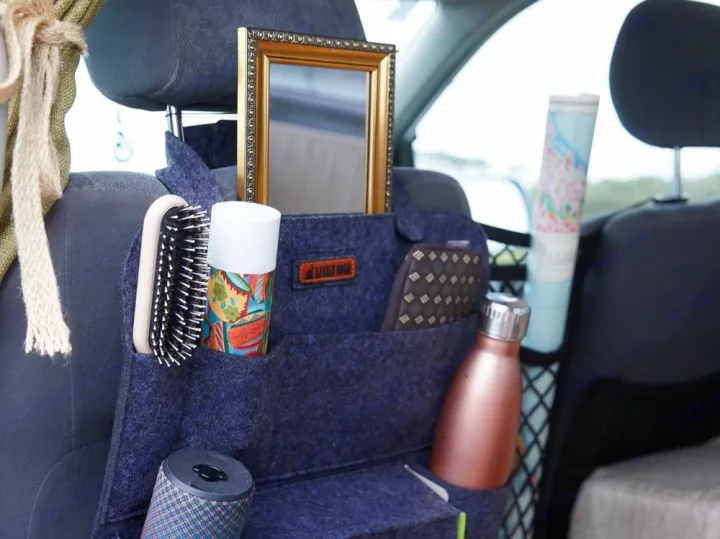 Felt seat-back organizer with travel essentials like a mirror, brush, and water bottle, ideal for your next RV rental road trip.. Toyota Voxy 2007