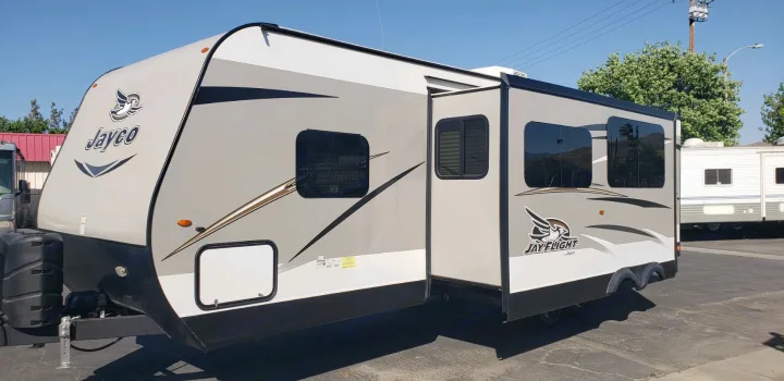 Explore with this light gray Jayco travel trailer, a spacious RV rental with an extended slide-out section.. Jayco Jay Flight 2019
