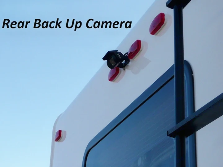 Close-up of a rear back-up camera on an RV rental, with red lights and a ladder. Enhances safety & parking.. Forest River Sunseeker 2025