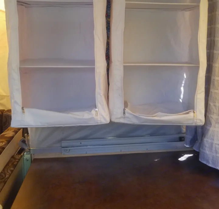Two soft-sided, multi-compartment storage shelves visible inside an RV rental, offering space-saving organization.. Forest River Rockwood Premier 2013