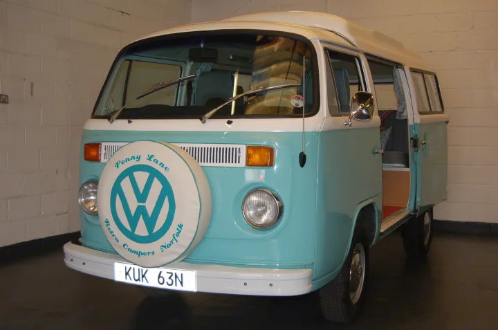 Classic light blue VW camper van, a charming RV rental, shown indoors with an open side door.. Volkswagen 2.0L T2 Late Bay 1975