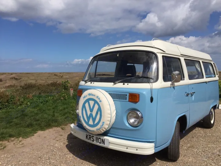 Light blue and white vintage VW campervan, 'Mr Blue Sky', in a scenic landscape; perfect rv rental for adventures.. Volkswagen 2.0L T2 Late Bay 1975