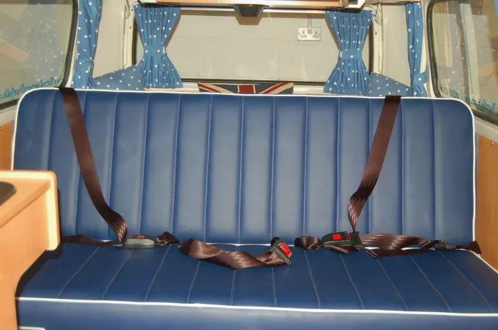 RV rental: A blue bench seat with three seatbelts. The cozy interior features polka dot curtains & a Union Jack.. Volkswagen 2.0L T2 Late Bay 1975
