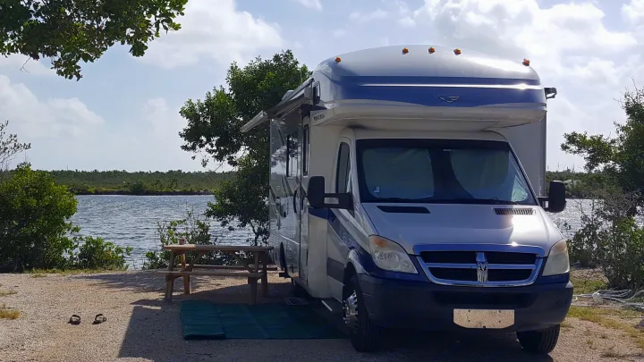 Waterfront rv rental: Class C motorhome by a lake, picnic table, & extended awning for a relaxing getaway.. Fleetwood Pulse 2009