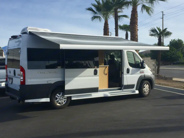 White Pleasure-Way camper van, ideal RV rental, with extended awning & open side door. Ready for travel.. FL #44 Lexor 2020