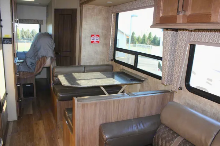 Spacious RV rental interior with dinette, bed area, and full living space for travel comfort.. Jayco Envoy 2018