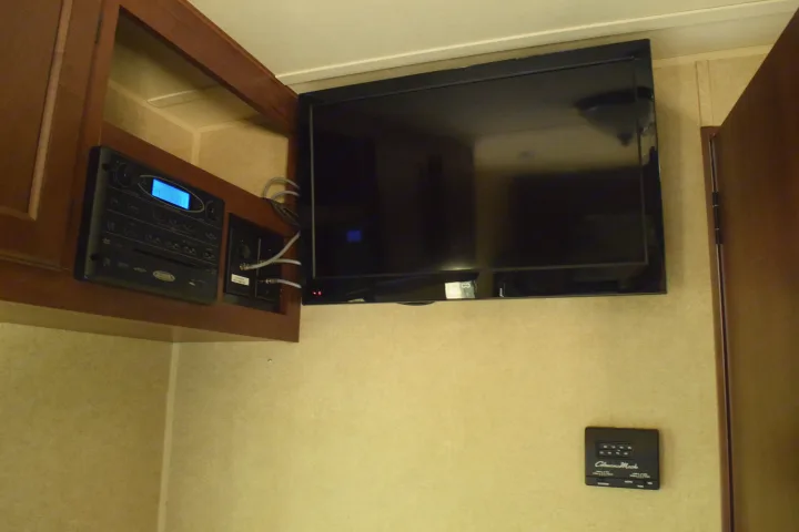 RV rental: Interior showing entertainment unit, TV, and Coleman Mach thermostat, ready for travel comfort.. Jayco Jay Flight 2014