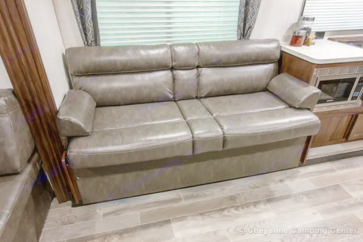 Plush gray faux leather RV sofa/sleeper, perfect for your RV rental. Compact comfort integrated with a kitchen.. Forest River Cherokee Grey Wolf 294rr 2020