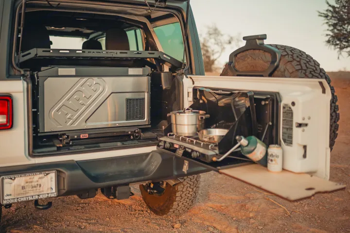 Jeep's rear reveals a portable ARB fridge & tailgate camp kitchen with stove. Ideal for an RV rental outdoor cooking adventure.. Jeep Wrangler Unlimited 2020