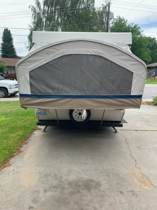 Rear view of an extended pop-up camper RV rental, showing its large screen window. Washington plate.. Coachmen Sport 2007