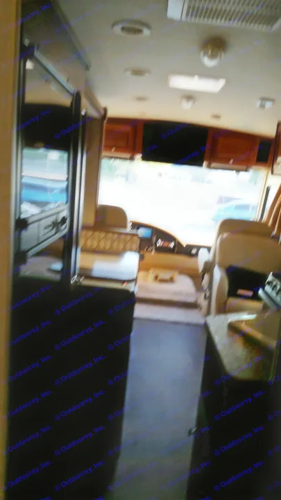 Interior of an RV rental, looking forward from the rear, showing the living area, dining, cockpit, and overhead lights.. Winnebago Vista 2015