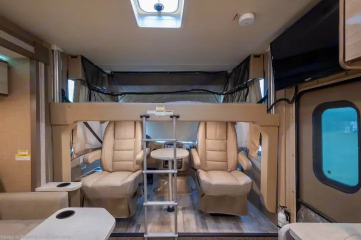 Explore this RV rental's versatile interior: cab-over bunk, swiveling driver seats, and comfortable living space.. Thor Motor Coach Vegas 24.1 2020