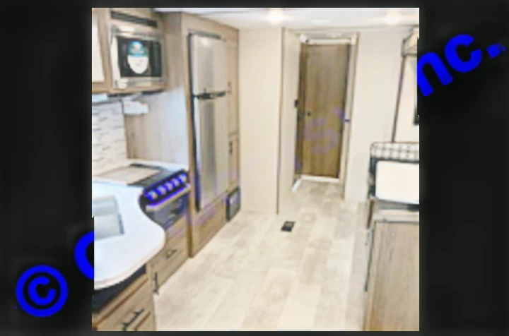 Step inside this modern RV rental! Features a compact kitchen with stainless appliances, living space, and hallway.. Prime Time Avenger 2021
