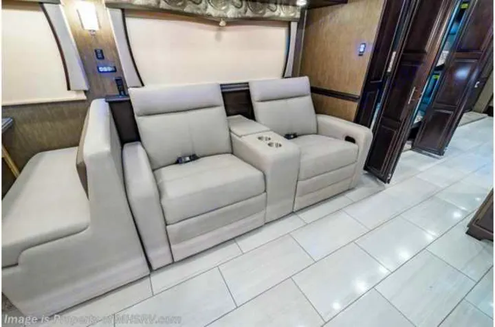 RV rental: Plush recliners with cup holders, an extending bench, and dark wood cabinets define this modern RV interior.. Forest River Berkshire 2020