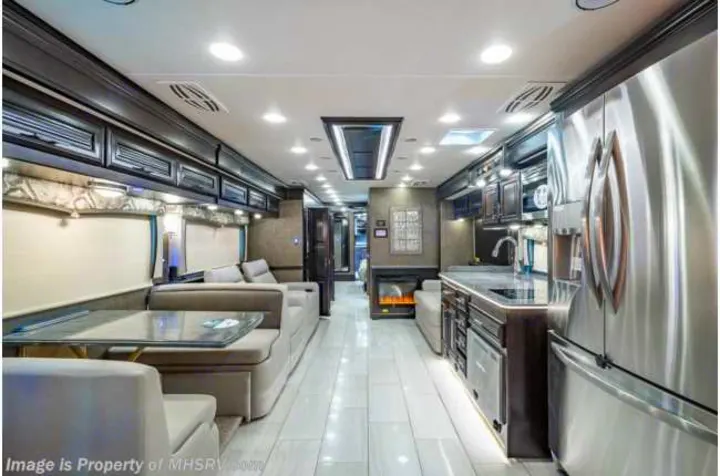 Experience luxury RV rental with this spacious motorhome interior, featuring a full kitchen & living area.. Forest River Berkshire 2020