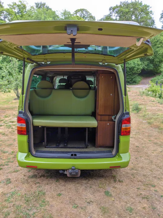Green van, tailgate open, shows a custom interior with green seats & wood storage. Great for an rv rental trip!. Volkswagen Other 2007