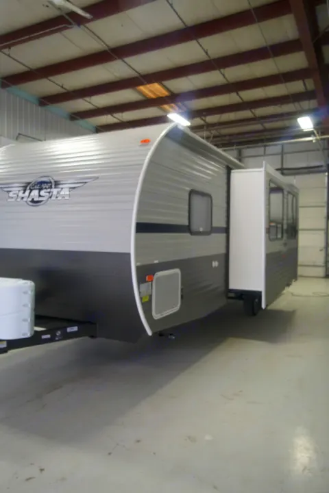 Indoor view of a grey Shasta travel trailer RV rental. Its slide-out is extended, offering more space.. Shasta Shasta 2020