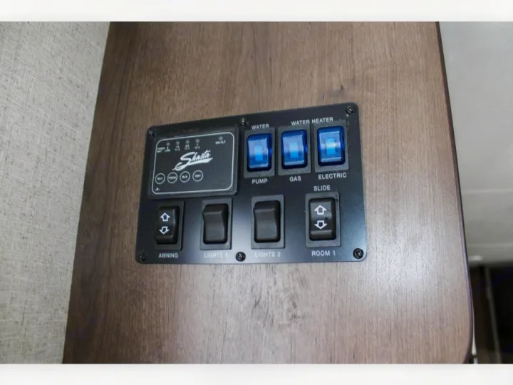 RV rental control panel: displays tank levels, water heater, pump, slide, and awning switches.. Shasta Shasta 2020