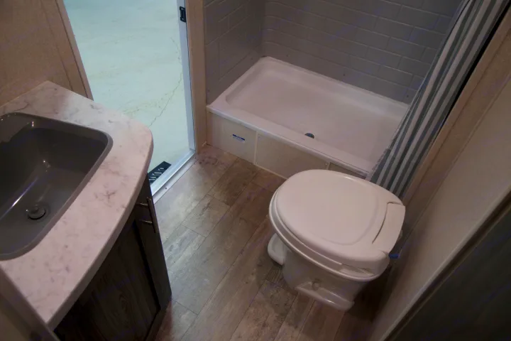 This RV rental boasts a well-equipped compact bathroom with a modern sink, toilet, and full shower.. Shasta Shasta 2020