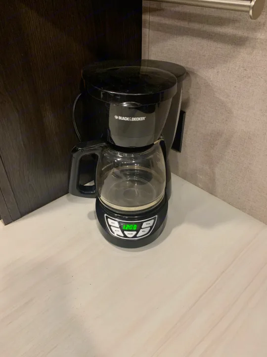 Black+Decker coffee maker displaying 12:00, a common amenity on the kitchen counter in this RV rental.. Forest River X-Lite 2018