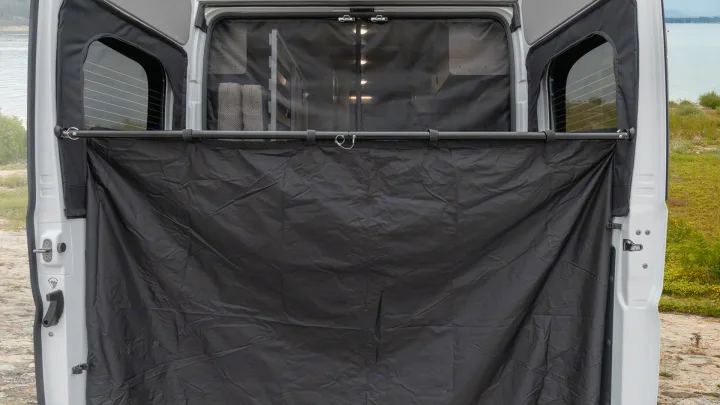 RV rental privacy curtain setup for van camping, offering comfort and privacy in an outdoor setting.. Winnebago Solis 2021