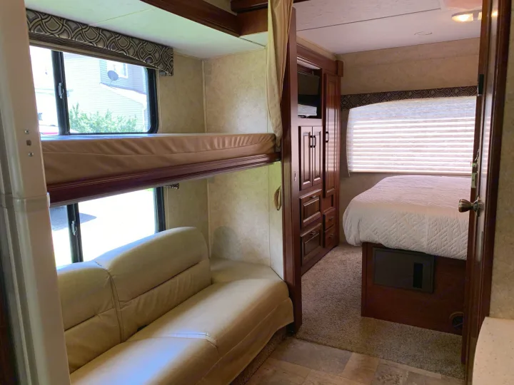 Double bunk beds for those kiddos. The couch on bottom pulls out for more room. Forest River Sunseeker 2014