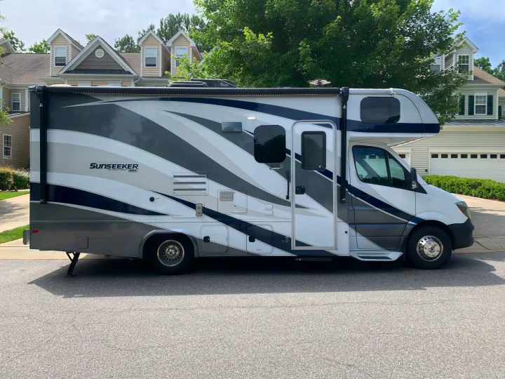 A white, grey, and blue Sunseeker Class C RV (motorhome) parked on asphalt, perfect for an rv rental adventure.. Forest River Sunseeker 2019