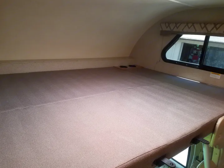 RV rental: Overhead bunk bed with a textured mattress, cup holders, and a side window for light.. Thor Four Winds 2020