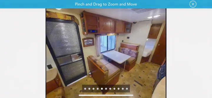 RV rental interior: cozy dinette, overhead cabinets, and a peek at the bedroom in this camper.. Northwood Mfg Nash 2014