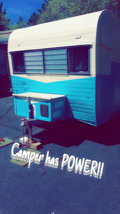 Vintage camper/RV rental now powered up! This two-tone unit, supported on jacks, is ready for adventures.. Nomad Rear fold 1962