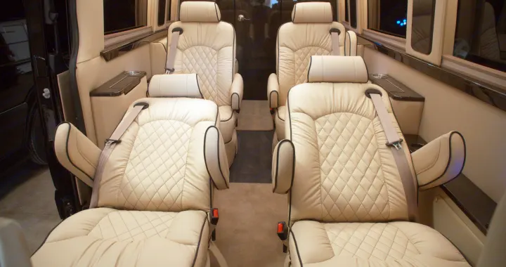 Step inside this premium RV rental: a spacious interior with quilted cream leather captain's chairs and refined amenities.. Ultimate Toys Presidential W/ Bath 2020